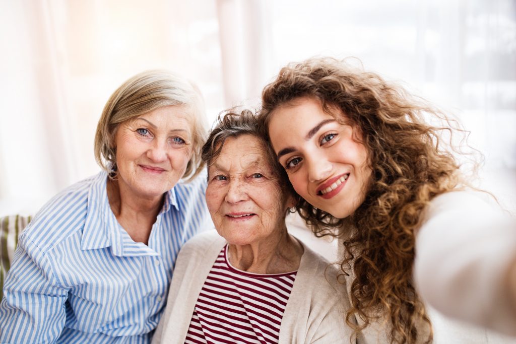 A teenage girl with mother and grandmother at home.